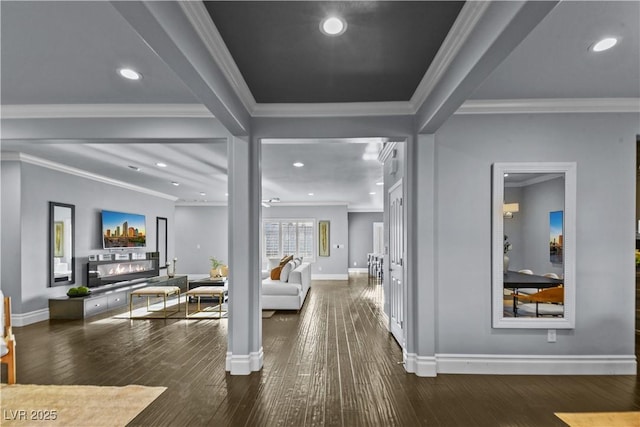 interior space with wood-type flooring, recessed lighting, baseboards, and ornamental molding
