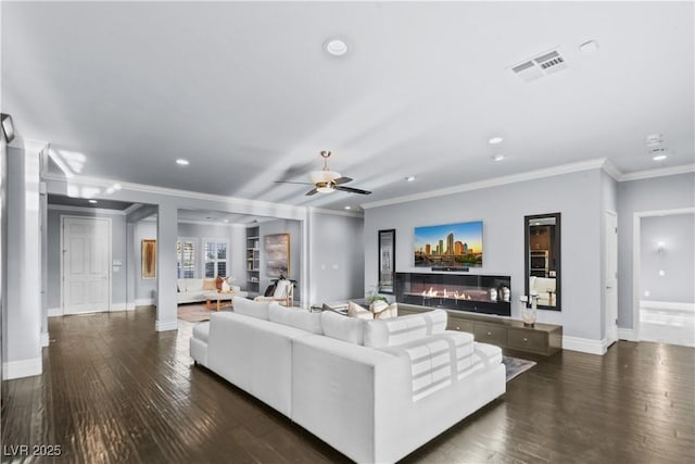 living area with baseboards, hardwood / wood-style flooring, recessed lighting, and visible vents
