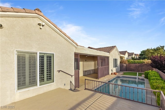 exterior space featuring a fenced in pool, a fenced backyard, and a patio area