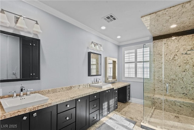 full bathroom with a sink, crown molding, a stall shower, and visible vents