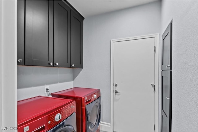 clothes washing area with cabinet space and washing machine and dryer