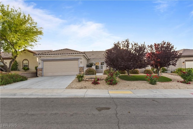 view of front of home with a garage, stucco siding, a tile roof, and concrete driveway