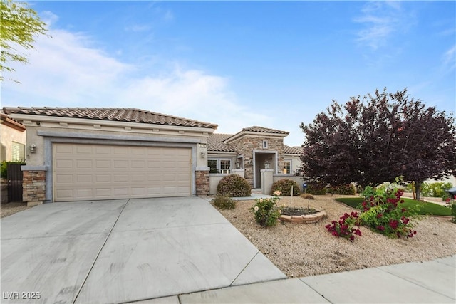 view of front of home with a tile roof, stone siding, a garage, stucco siding, and concrete driveway