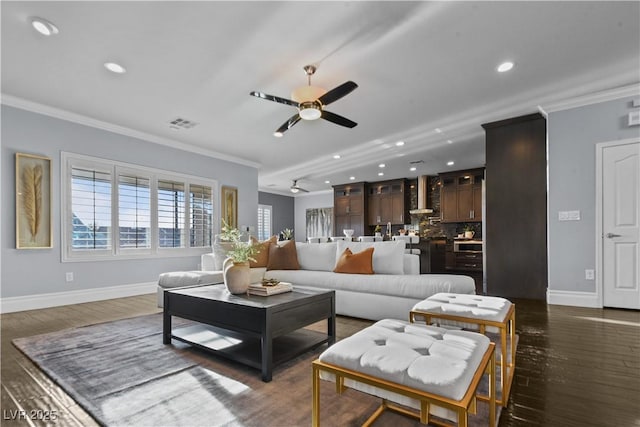 living area with crown molding, recessed lighting, baseboards, and ceiling fan