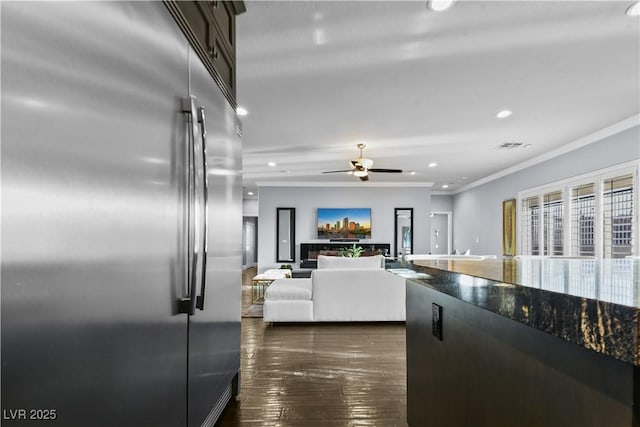 kitchen featuring ornamental molding, dark wood-style flooring, recessed lighting, stainless steel built in fridge, and a ceiling fan