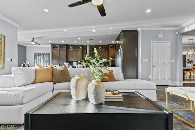 living area featuring recessed lighting, a ceiling fan, wood finished floors, and ornamental molding