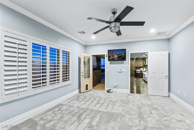 unfurnished bedroom featuring carpet flooring, baseboards, visible vents, and ornamental molding