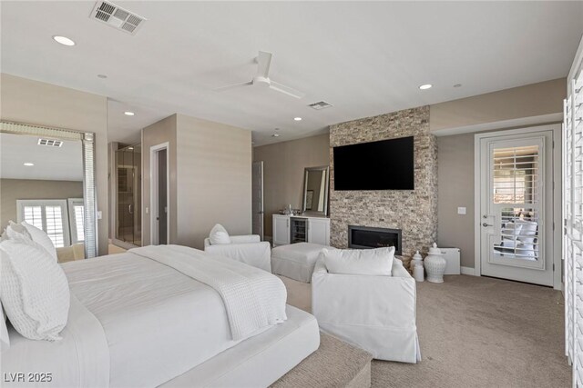 bedroom featuring visible vents, carpet, a fireplace, and access to exterior