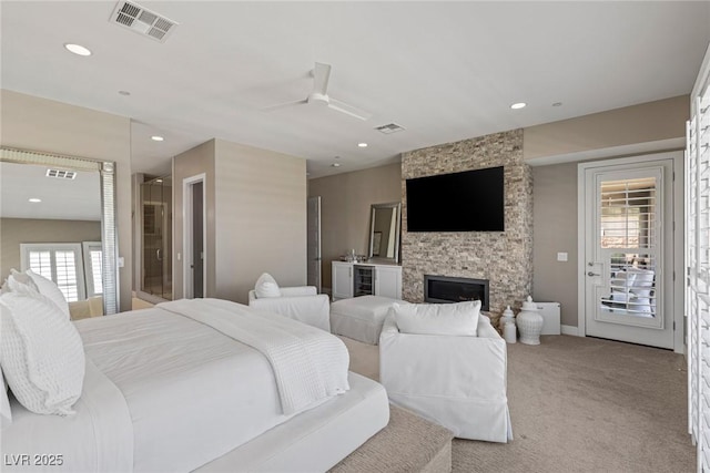2 Olympia Outlook Dr, Las Vegas, NV 89141 - bedroom featuring wine cooler, access to exterior, carpet flooring, a stone fireplace, and recessed lighting