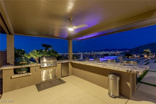 2 Olympia Outlook Dr, Las Vegas, NV 89141 - patio at night featuring an outdoor kitchen, a ceiling fan, and a patio