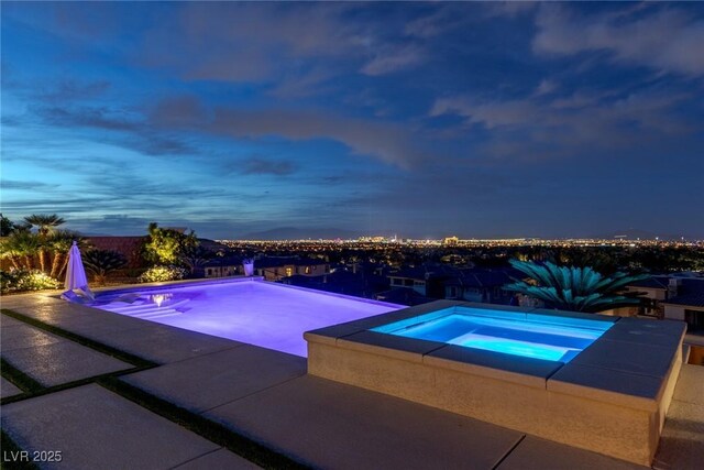 pool featuring an in ground hot tub
