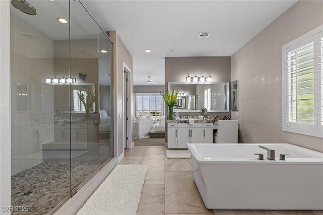 bathroom with vanity, visible vents, recessed lighting, a freestanding bath, and a stall shower