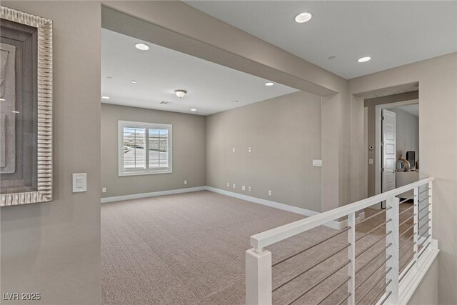 empty room featuring baseboards, recessed lighting, and carpet floors