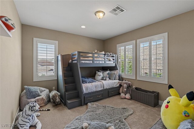 carpeted bedroom featuring visible vents