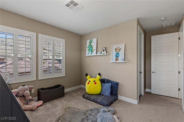 interior space with carpet flooring, baseboards, and visible vents
