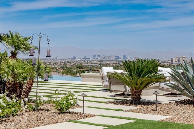 view of yard with a view of city and a mountain view