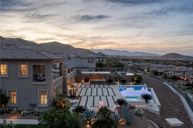 view of swimming pool with a fenced backyard, a fenced in pool, a mountain view, and a patio area
