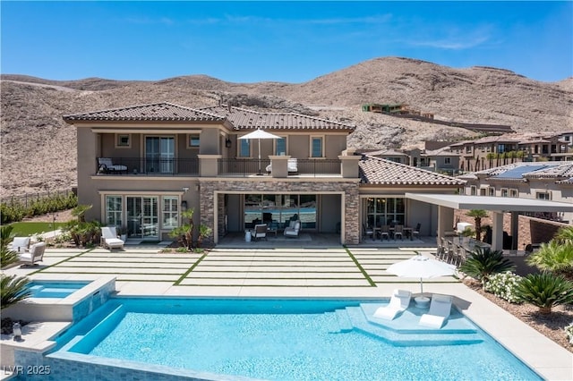 2 Olympia Outlook Dr, Las Vegas, NV 89141 - back of house featuring a balcony, stucco siding, a mountain view, a tile roof, and a patio