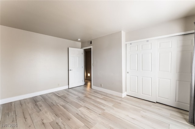 5020 Indian River Dr Unit 424, Las Vegas, NV 89103 - unfurnished bedroom featuring baseboards, a closet, light wood finished floors, and visible vents