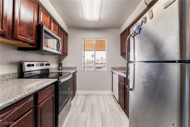 5020 Indian River Dr Unit 424, Las Vegas, NV 89103 - kitchen with light countertops, appliances with stainless steel finishes, baseboards, and light wood-type flooring