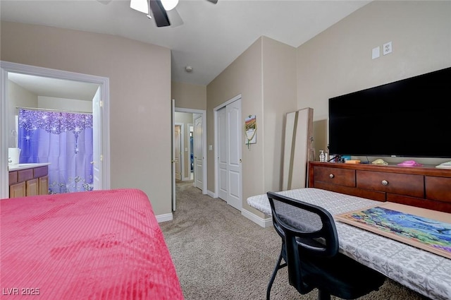 carpeted bedroom with baseboards, ensuite bathroom, a ceiling fan, and a closet