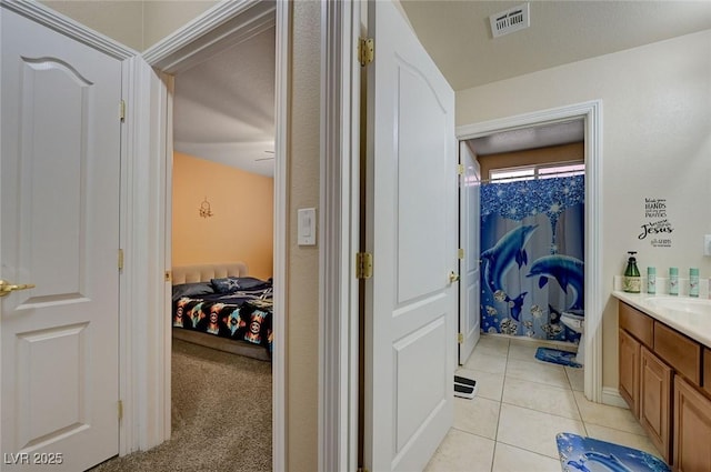 bathroom featuring vanity, tile patterned floors, connected bathroom, and visible vents