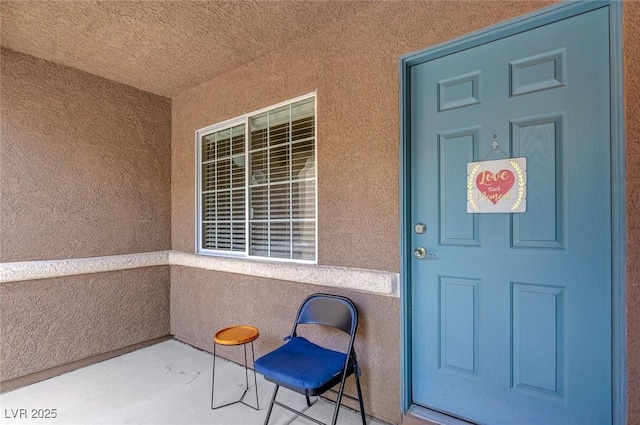 doorway to property with stucco siding