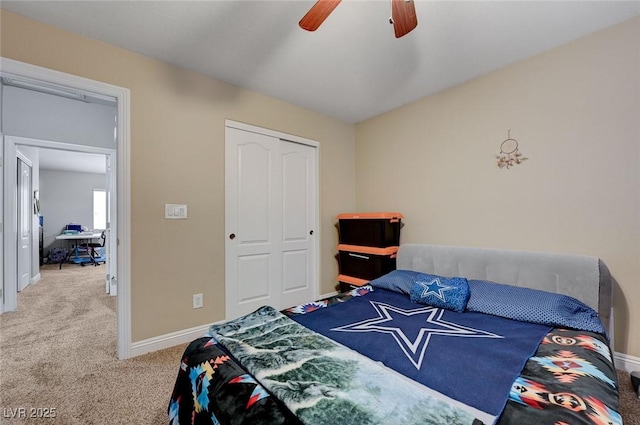 bedroom featuring baseboards, ceiling fan, carpet, and a closet