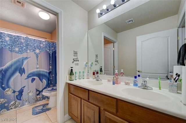 bathroom featuring a sink, tile patterned floors, and visible vents