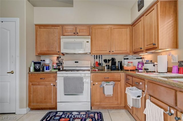 kitchen featuring white appliances, light tile patterned flooring, light stone countertops, and lofted ceiling