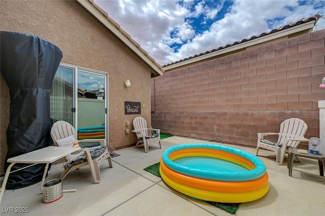 view of patio featuring fence