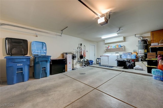 garage with water heater, a garage door opener, and washer and clothes dryer