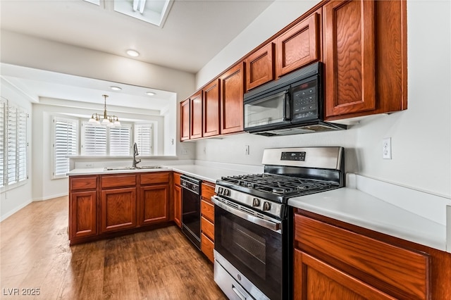 10029 Netherton Dr, Las Vegas, NV 89134 - kitchen featuring light countertops, a sink, black appliances, and dark wood-style floors