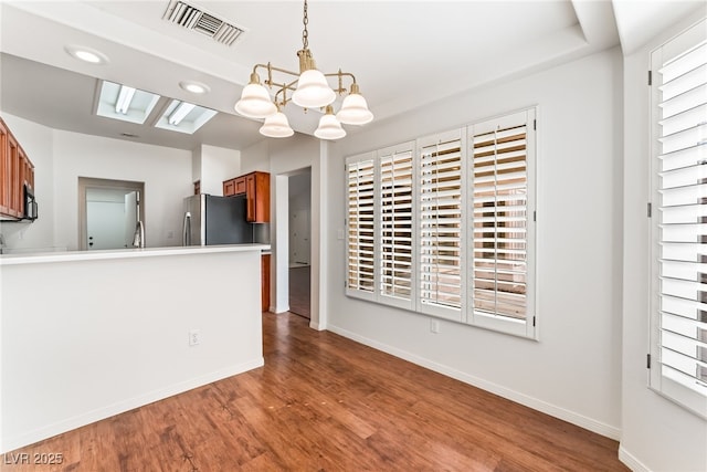 10029 Netherton Dr, Las Vegas, NV 89134 - unfurnished dining area featuring baseboards, a notable chandelier, wood finished floors, and visible vents