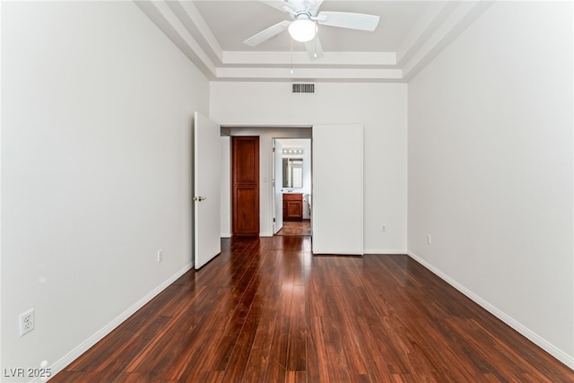 10029 Netherton Dr, Las Vegas, NV 89134 - spare room with ceiling fan, dark wood finished floors, baseboards, a tray ceiling, and visible vents