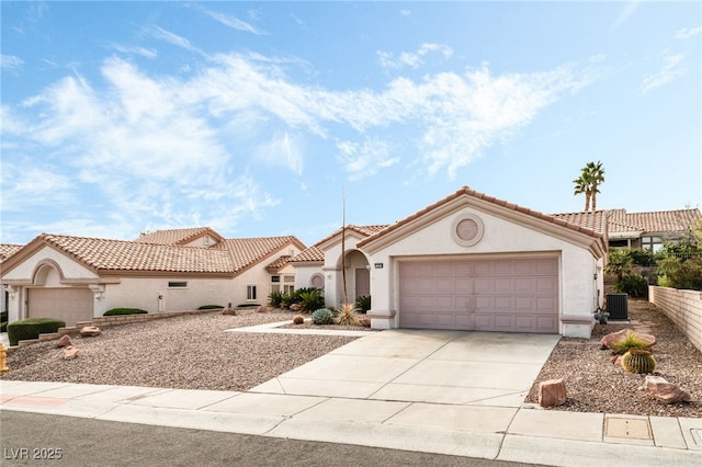 10029 Netherton Dr, Las Vegas, NV 89134 - mediterranean / spanish home featuring central AC unit, stucco siding, an attached garage, and driveway