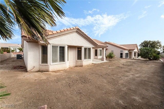 10029 Netherton Dr, Las Vegas, NV 89134 - back of house with central AC unit, a tile roof, and stucco siding