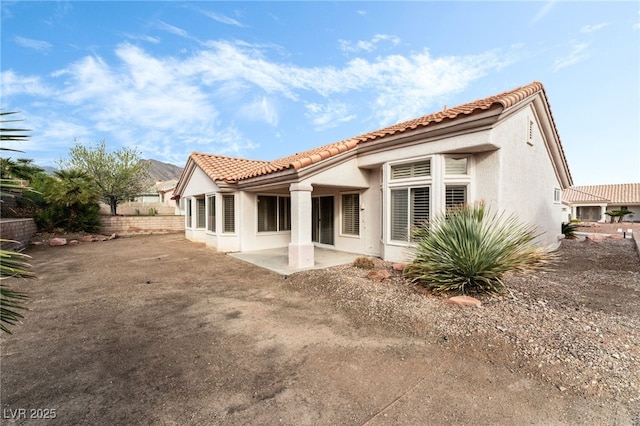 10029 Netherton Dr, Las Vegas, NV 89134 - rear view of house with a tiled roof, a patio, fence, and stucco siding
