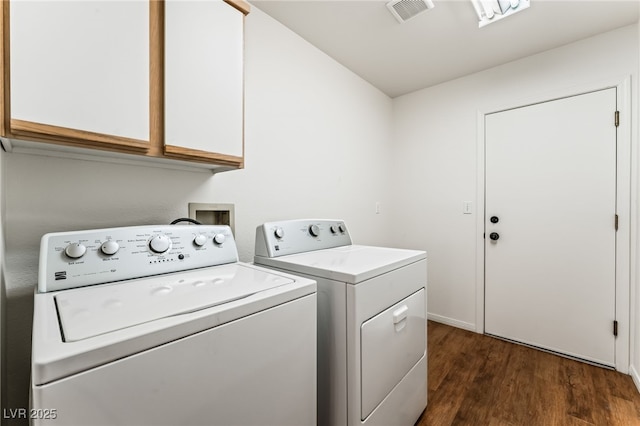 10029 Netherton Dr, Las Vegas, NV 89134 - laundry area featuring visible vents, cabinet space, dark wood finished floors, and washing machine and clothes dryer