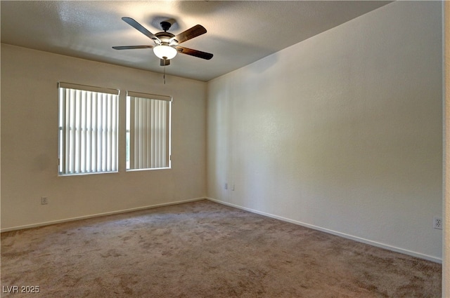 spare room featuring baseboards, ceiling fan, and carpet flooring