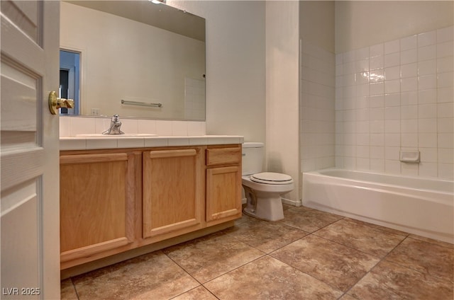 bathroom with toilet, tile patterned floors,  shower combination, and vanity