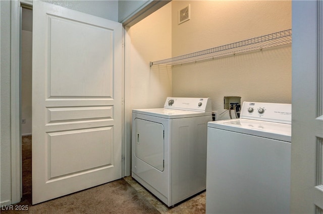 clothes washing area featuring separate washer and dryer, light carpet, laundry area, and visible vents