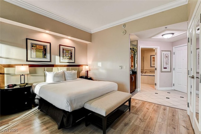 bedroom with light wood-type flooring, ornamental molding, baseboards, and ensuite bathroom