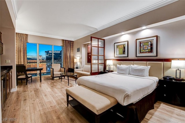 bedroom featuring crown molding and light wood-style flooring