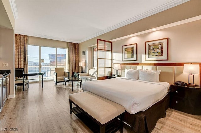 bedroom with ornamental molding and light wood finished floors