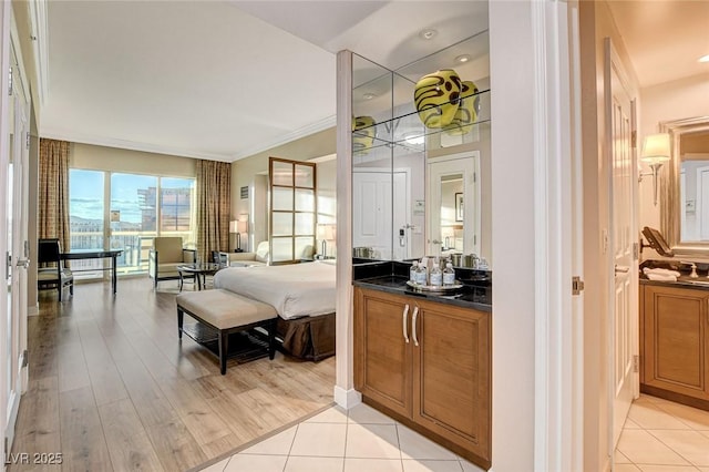 bedroom featuring ornamental molding and light tile patterned flooring