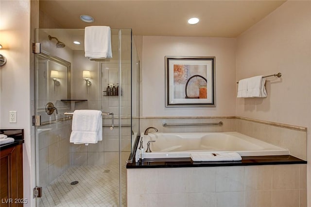 bathroom featuring vanity, a stall shower, a bath, and recessed lighting