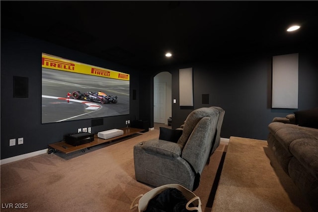home theater room featuring arched walkways, baseboards, carpet flooring, and recessed lighting