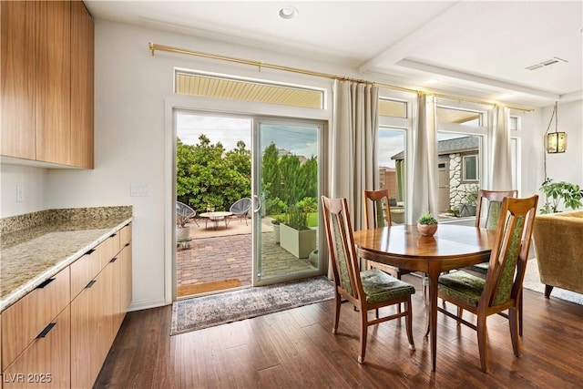 dining space with visible vents and dark wood finished floors
