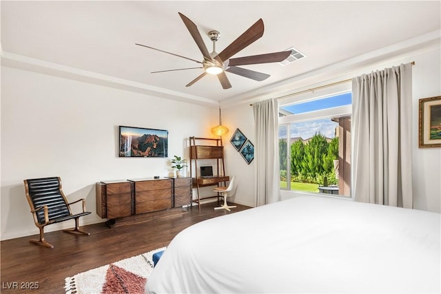 bedroom with visible vents, baseboards, ceiling fan, and wood finished floors